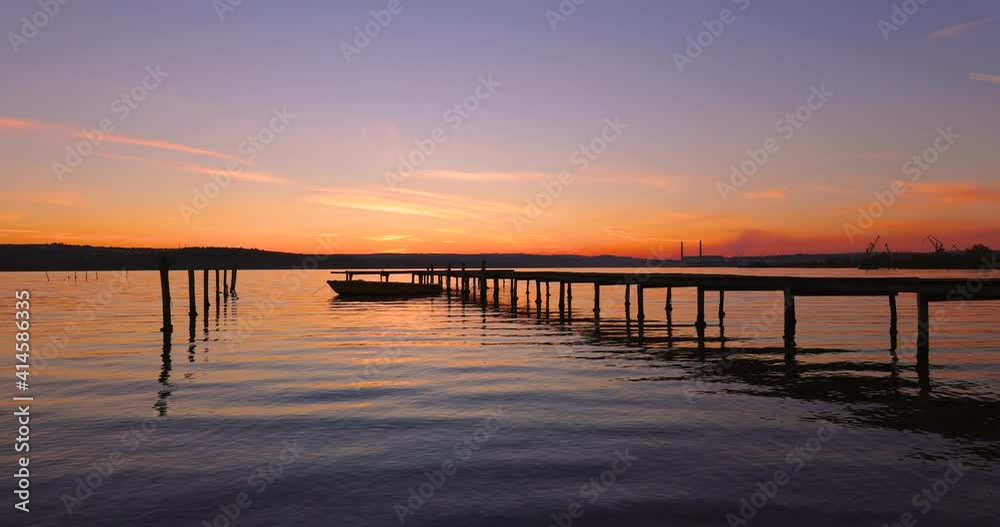 Small Dock and Boat at the lake.Sunset over the lake. Small Dock and Boat. Small Dock and Boat at the lake.Sunset over the lake. Small Dock and Boat.