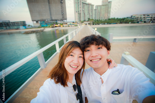 Valentine concept, Joyful young loving couple do selfie togeher on bride at outdoor photo