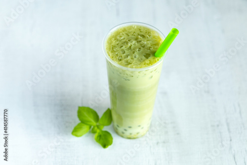 Green Thai Tea with Boba on white background.