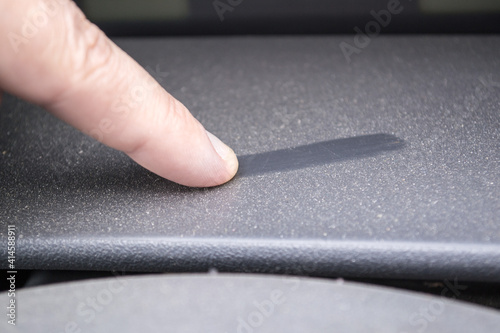 swipes his finger across a dusty plastic surface