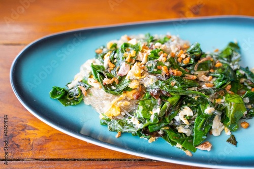 Bai Lieng Pad Kai:stir fried malindjo leaves with egg photo