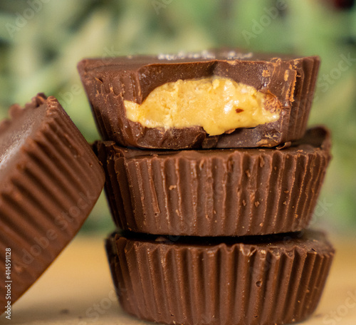Stack of peanut butter cups on green background