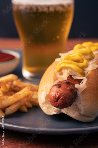 Hotdog with fries and a beer