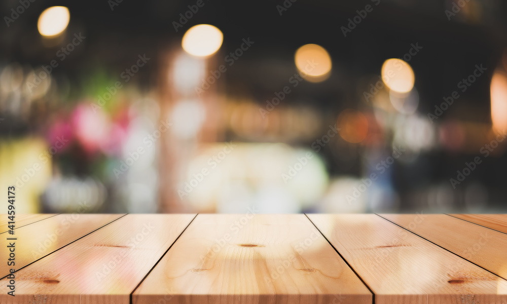 Empty wooden top table on blur restaurant background.
