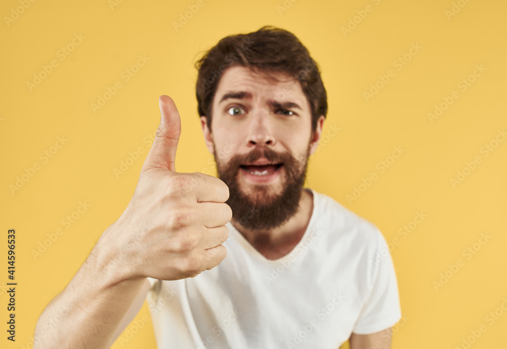 man in a t-shirt positive gesture with his hands white t-shirt bushy beard man in a t-shirt positive gesture with his hands white t-shirt bushy beard