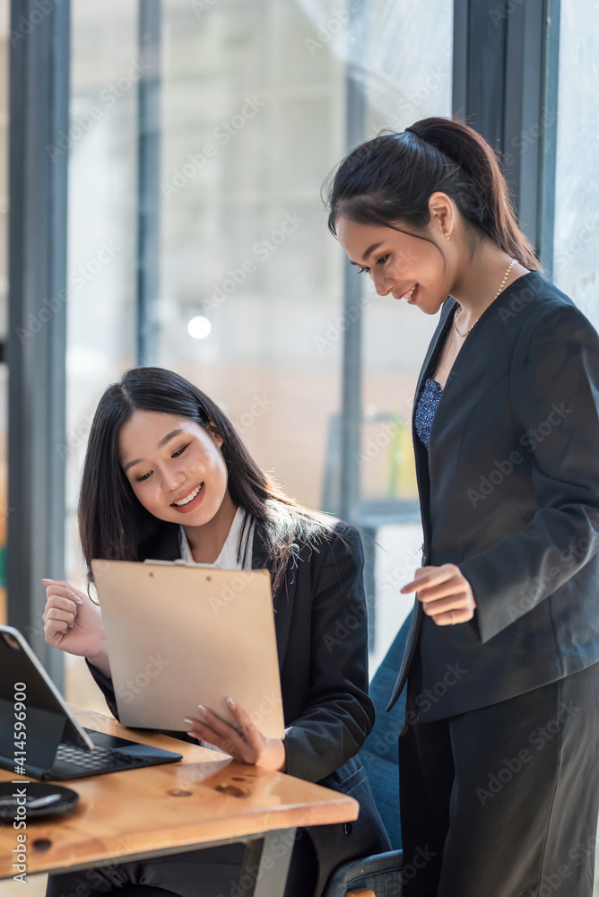 Asian businesswoman plan and analyze collaboration ideas using a tablet and document at the office. Asian businesswoman plan and analyze collaboration ideas using a tablet and document at the office.