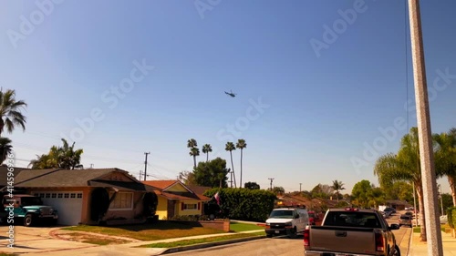 Helicopter circling over some houses in a southern California neighborhood. photo