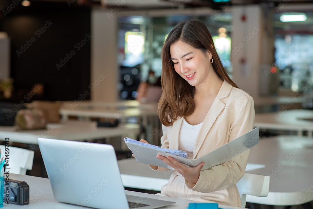Asian businesswoman working in the office with working documents. Asian businesswoman working in the office with working documents.