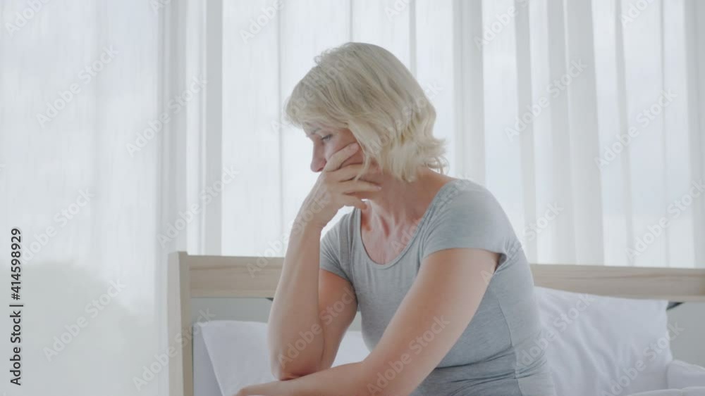 Medium shot – Stressed Caucasian senior woman sighs and looks away worrying about personal or health problems. Isolated senior woman with mental health suffering from depression concept. Medium shot – Stressed Caucasian senior woman sighs and looks away worrying about personal or health problems. Isolated senior woman with mental health suffering from depression concept.
