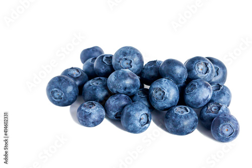 Ripe fresh blueberry in bulk lies on an isolated white background. 