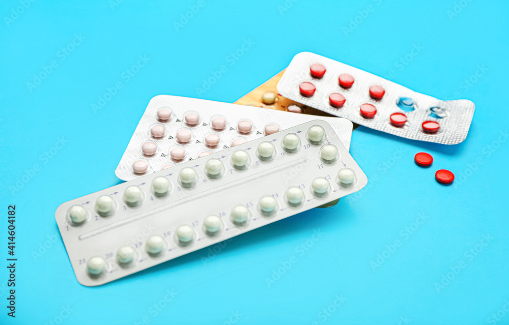Strips of different birth control pills on color background Strips of different birth control pills on color background