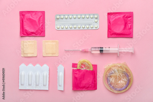 Different contraceptives on color background photo
