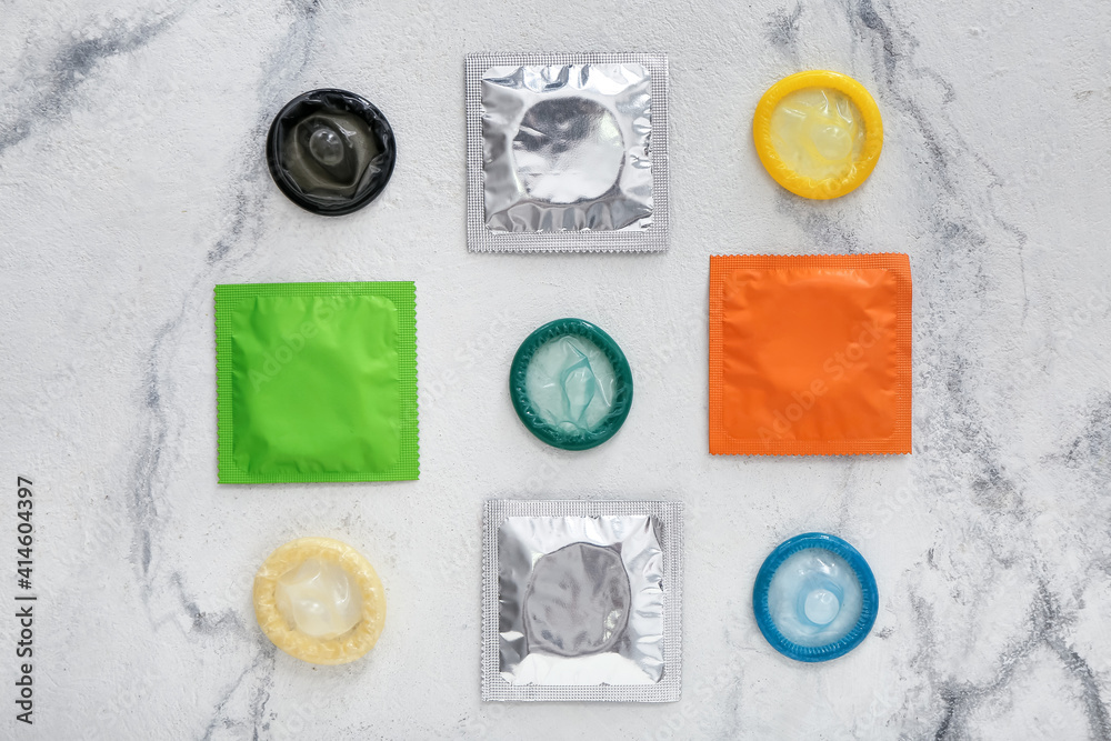 Wrapped and open condoms on light background Wrapped and open condoms on light background
