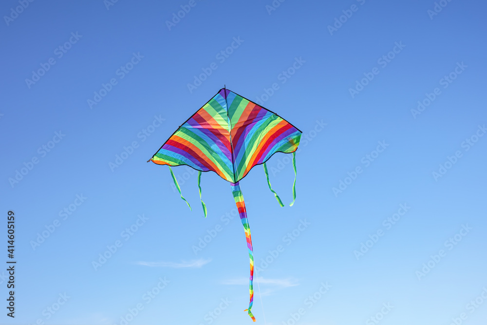 Colorful kite flying in blue sky