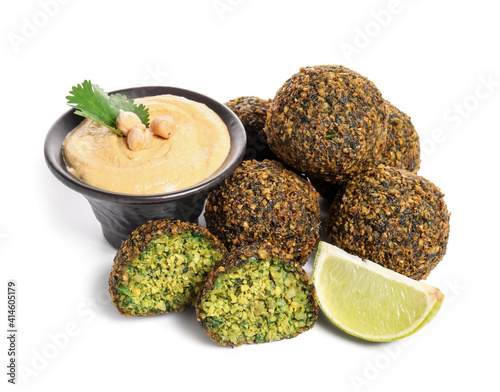 Tasty falafel balls with sauce on white background photo