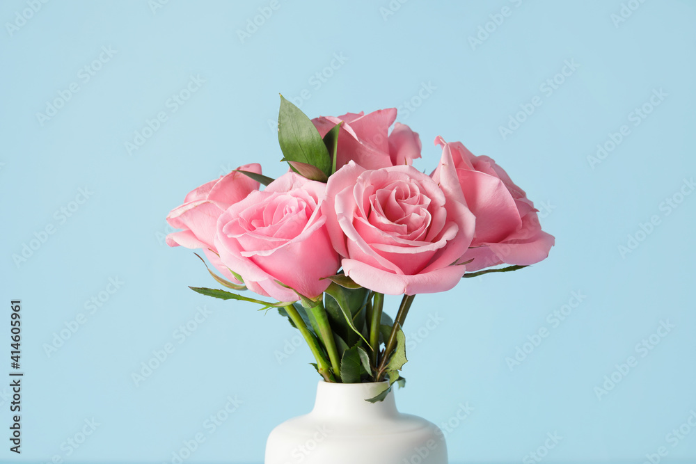 Beautiful pink roses in vase on color background Beautiful pink roses in vase on color background