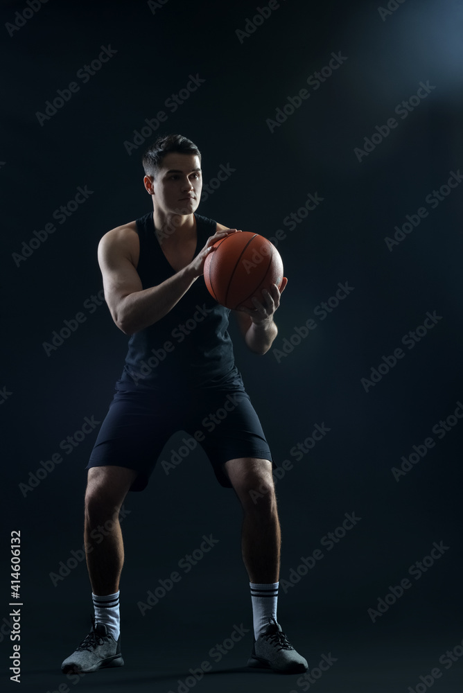 Male basketball player on dark background Male basketball player on dark background