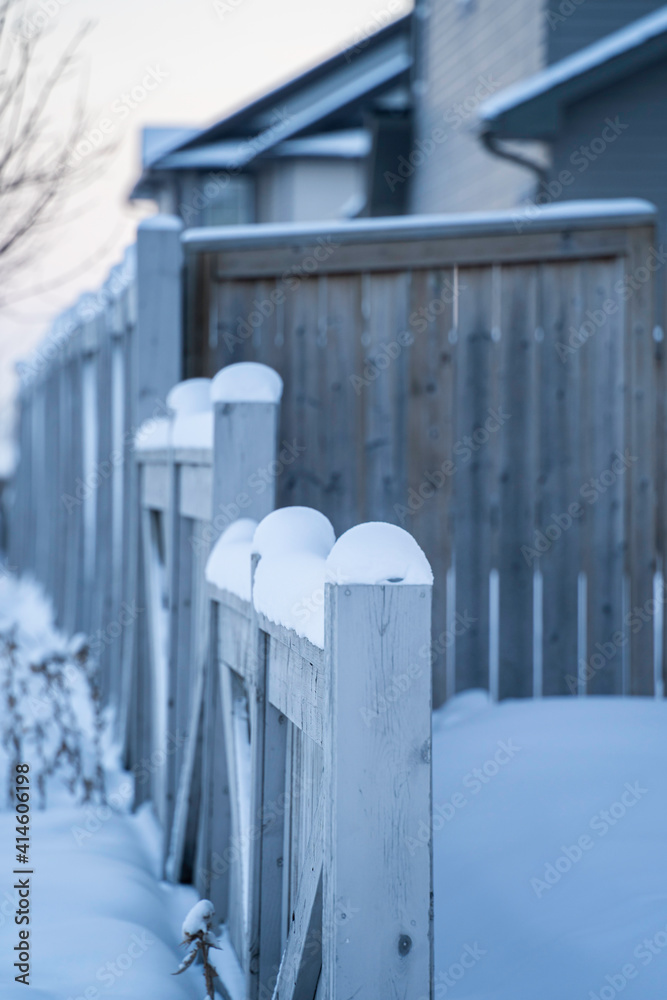 house fence covered with snow in winter
