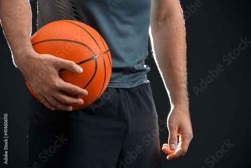 Male basketball player on dark background, closeup