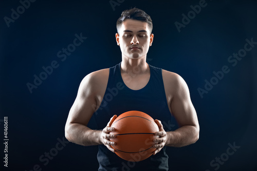 Male basketball player on dark background © Pixel-Shot
