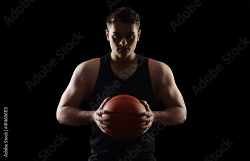 Male basketball player on dark background © Pixel-Shot