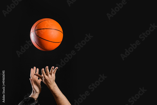 Male basketball player with ball on dark background © Pixel-Shot