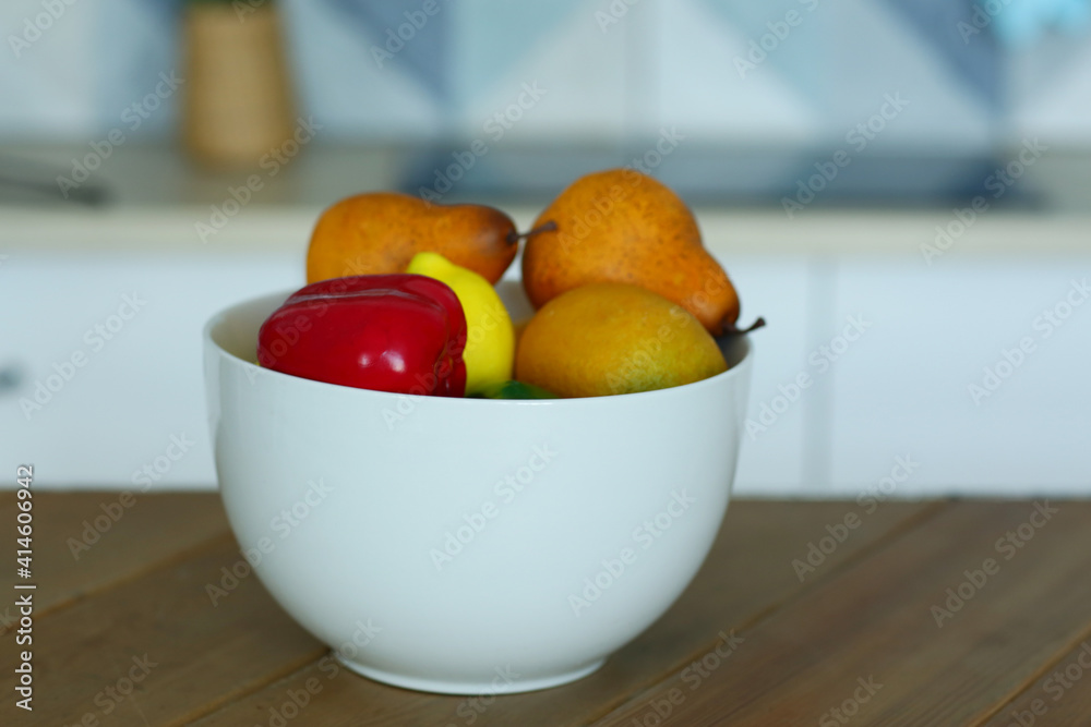 fruit in bowl still life on the table closeup photo on blue kitchen background fruit in bowl still life on the table closeup photo on blue kitchen background
