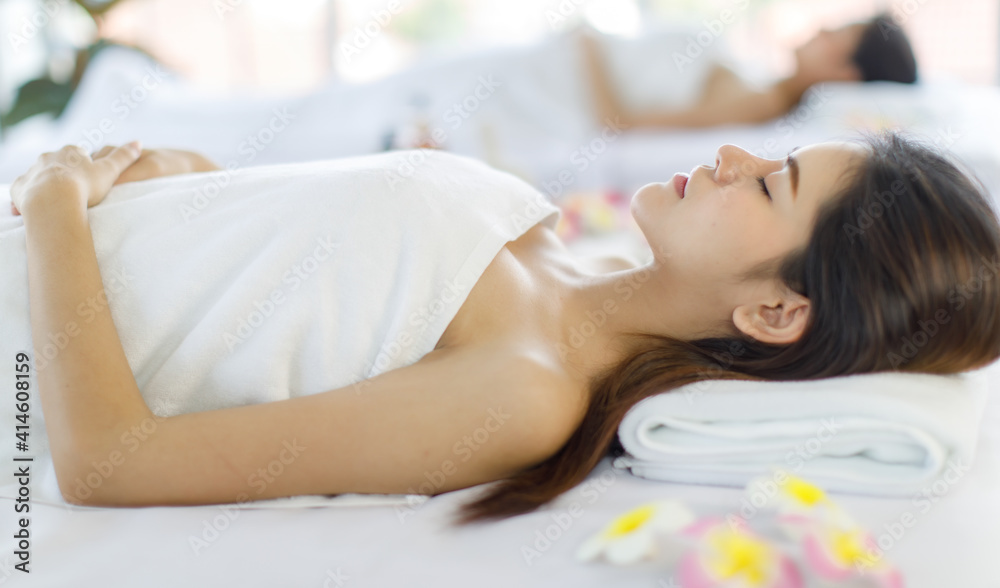 Portrait beautiful asian women black long hair sleep waiting to spa massage service with covered wrap by white towel on her and white pillow look feel relax Portrait beautiful asian women black long hair sleep waiting to spa massage service with covered wrap by white towel on her and white pillow look feel relax
