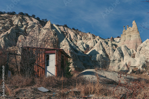 cabin in front of a rock formation in the desert of cappadocia