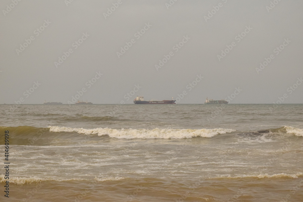 A beautiful view of sea waves and ship in the background A beautiful view of sea waves and ship in the background