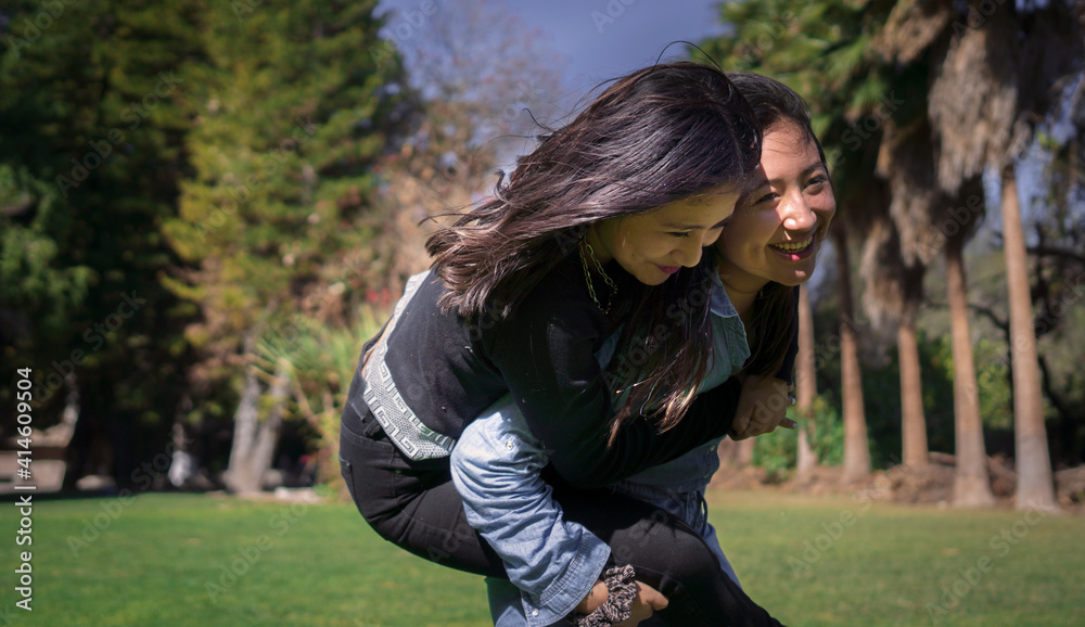 happy friends hugging and playing in a park happy friends hugging and playing in a park