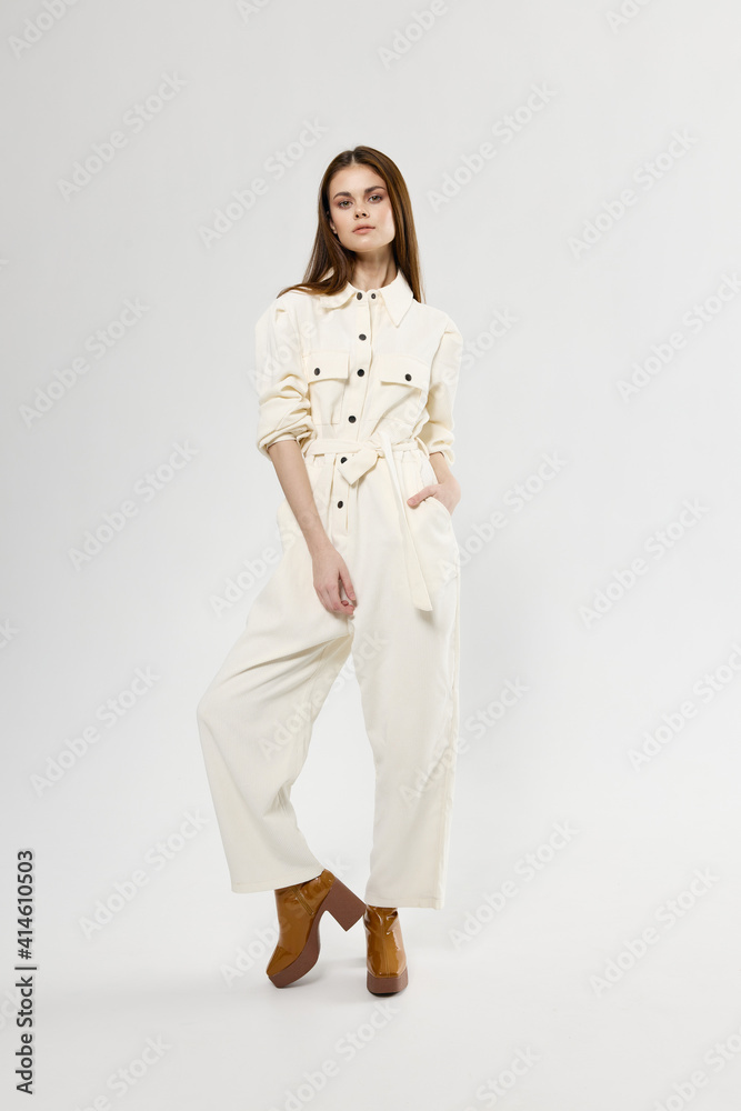 beautiful brunette in a jumpsuit and brown boots in full growth beautiful brunette in a jumpsuit and brown boots in full growth