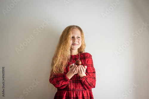 girl in a red dress with easter eggs, selective focus