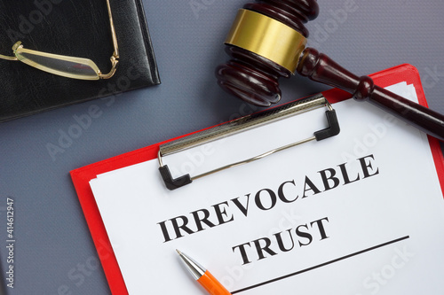 Irrevocable trust document on the clipboard and gavel. photo