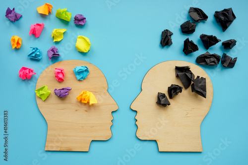 Negative and positive thinking concept. Head shapes with color paper balls.