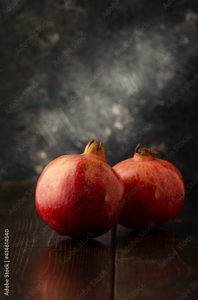 pomegranate and whole with garnet grains in a bow pomegranate and whole with garnet grains in a bow