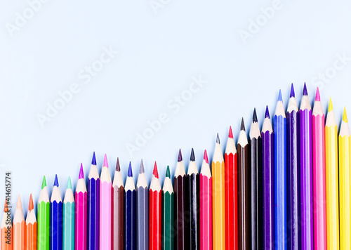 Set of colorful pencils on the light blue background.