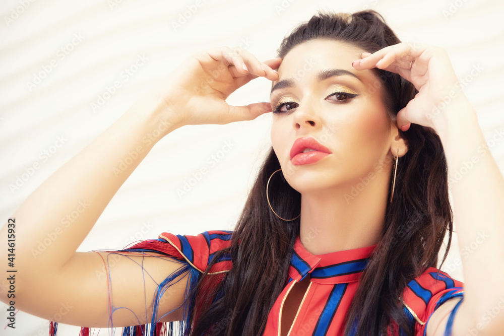 Fototapeta premium Fashion portrait of brunette girl wearing red and blue dress
