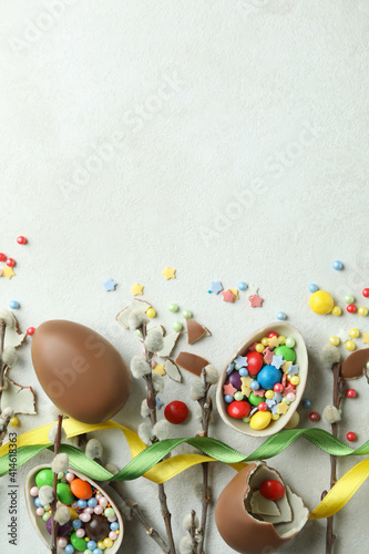 Easter concept with chocolate eggs on white textured background © Atlas