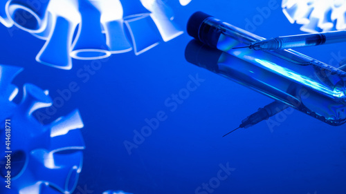 Vaccine isolated. Medical syringe with needle for protection flu virus and coronavirus. Covid immunization isolated on blue. Concept fight against virus covid-19.