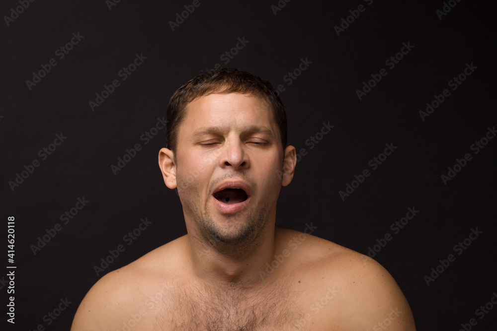 Yawning man on the black background. Muscular and athletic.
Man portrait. Male model in studio
Yawning man on the black background. Muscular and athletic.
Man portrait. Male model in studio