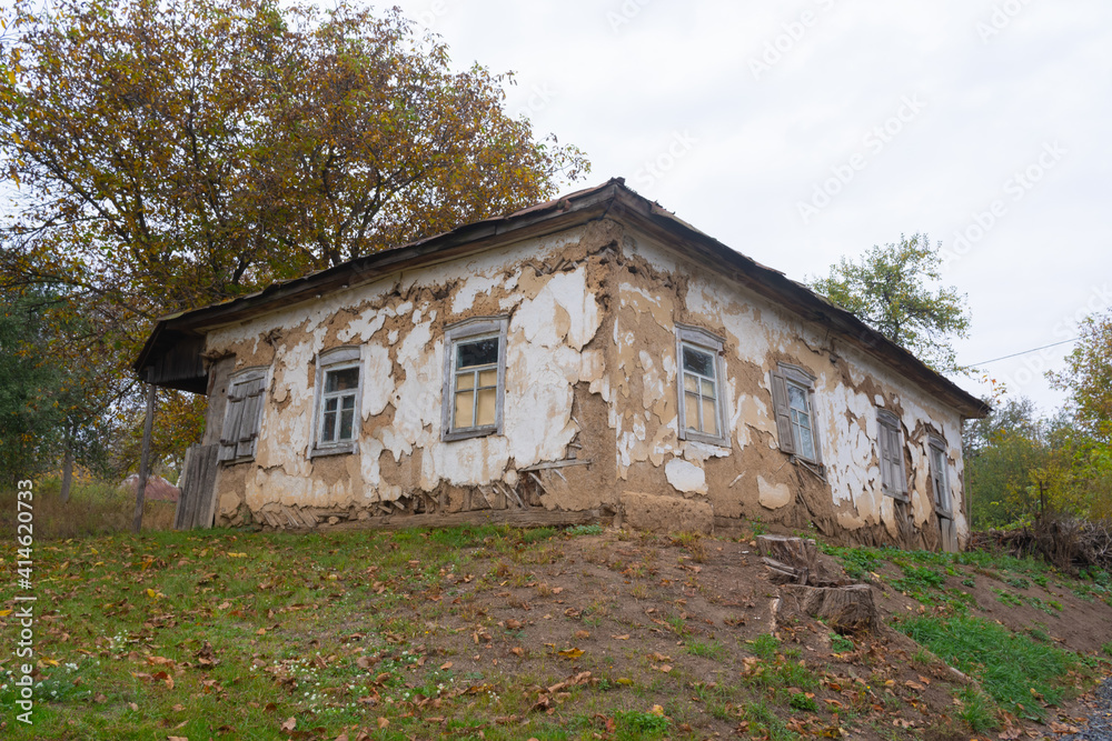 Old abandoned house with clay walls and wooden windows in Poltava region, Ukraine Old abandoned house with clay walls and wooden windows in Poltava region, Ukraine