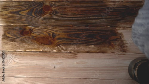Painting wood with a brush with brown paint