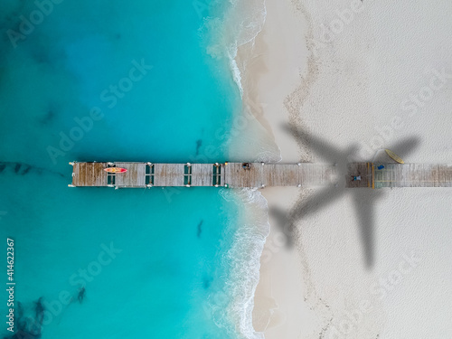 Drone photo of pier in Grace Bay, Providenciales, Turks and Caicos, airplane shadow