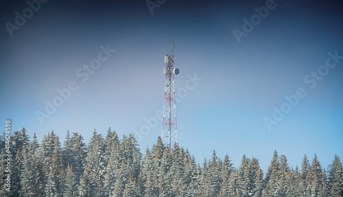 GSM communication internet antenna on top of a hill surrounded by forest in winter landscape © Dragoș Asaftei