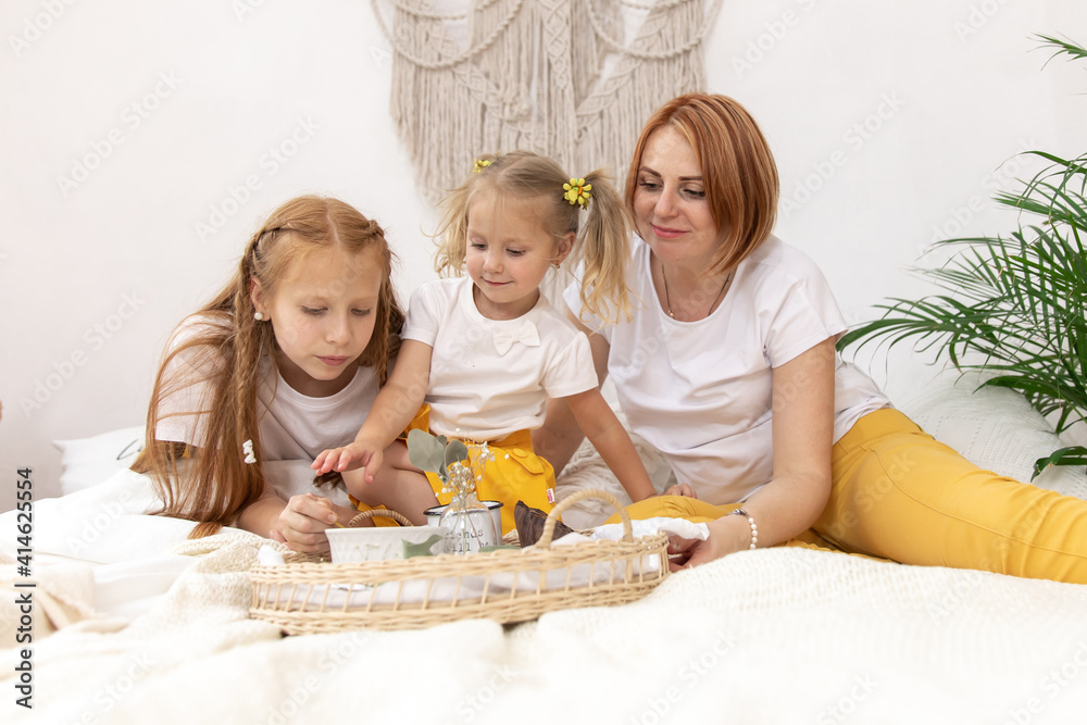 Family of five and their cat having breakfast in their bed in the morning Family of five and their cat having breakfast in their bed in the morning