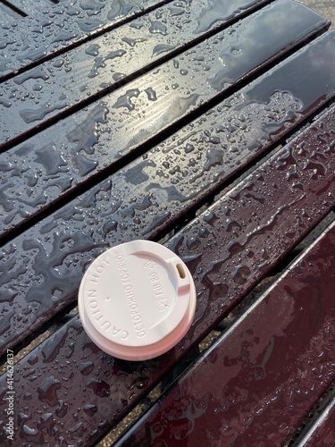 wooden table with the coffee cup after the rain 