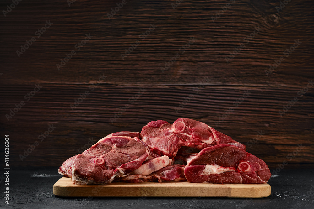 Assortment of raw lamb meat on wooden tray