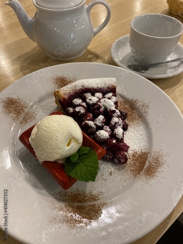 chocolate cake with berries and tea in a cafe 