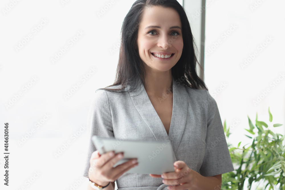 Portrait of smiling woman holding tablet closeup Portrait of smiling woman holding tablet closeup